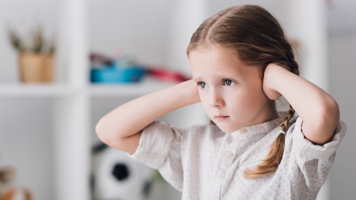 child covering ears
