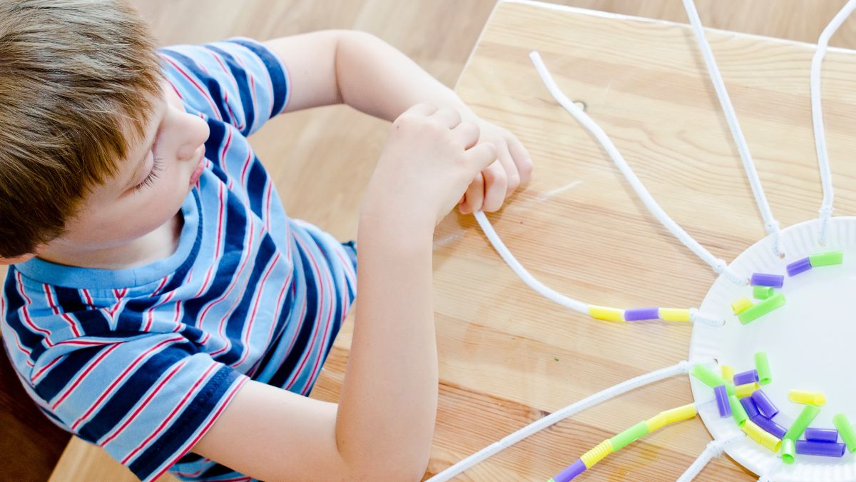 child with hands on learning toy