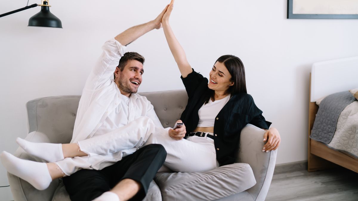 couple high fiving on couch