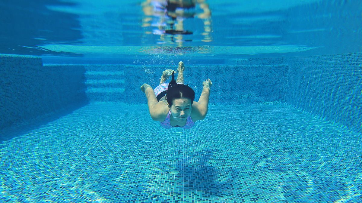 girl swimming under water