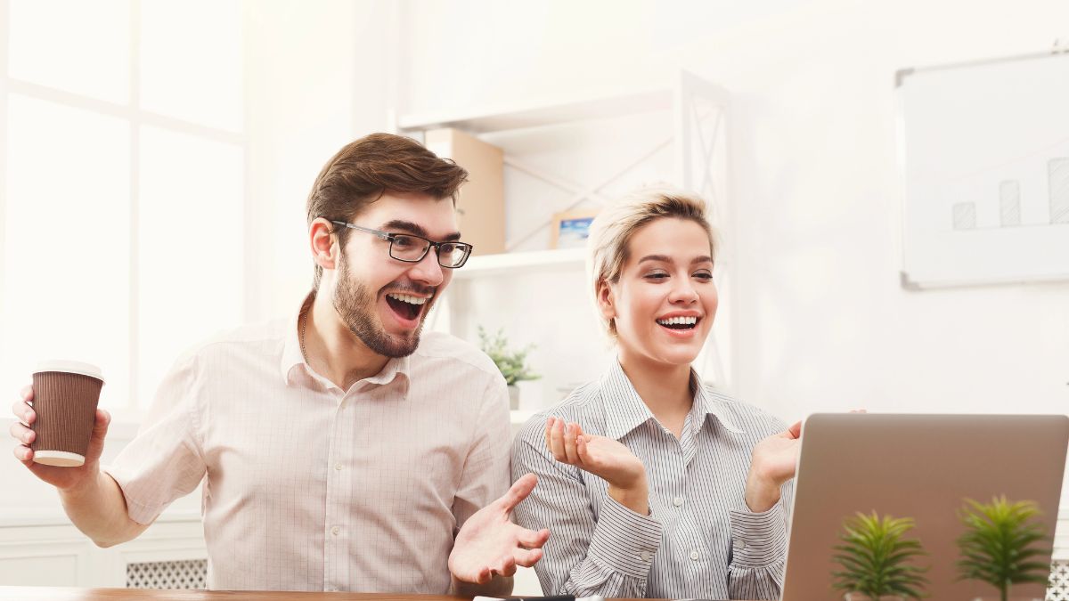 happy man and woman on computer