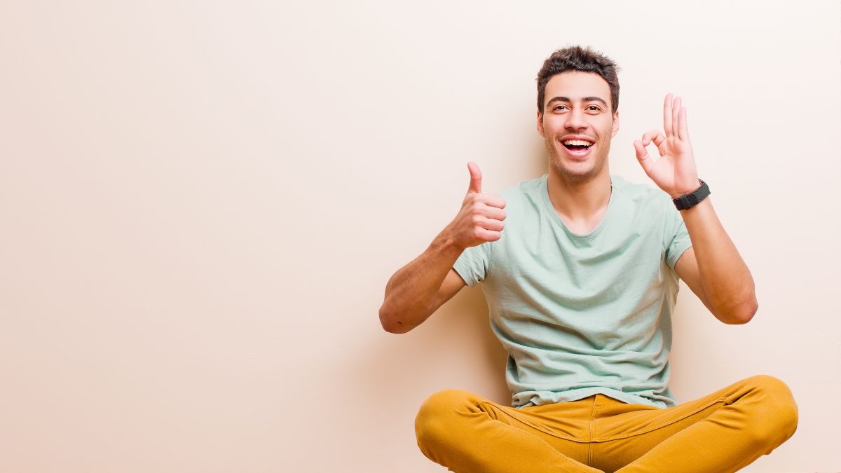 happy man sitting with thumbs up