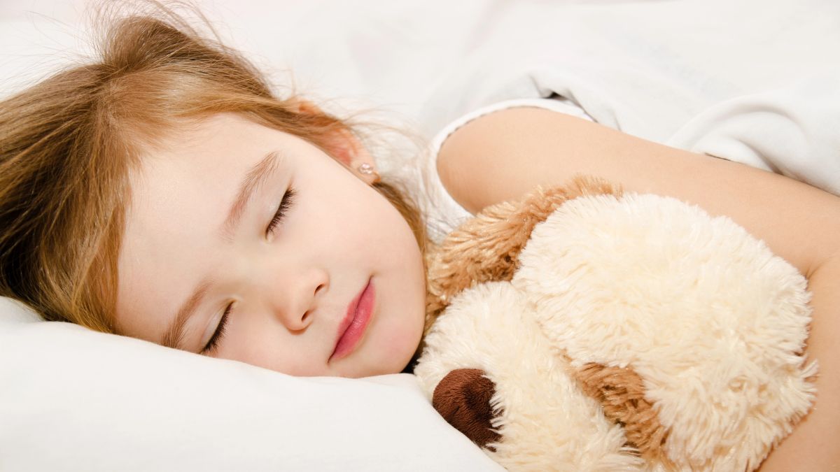 little girl sleeping with dog toy