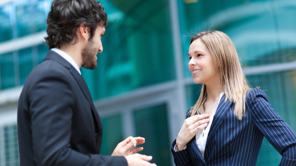 man and woman talking outside of work