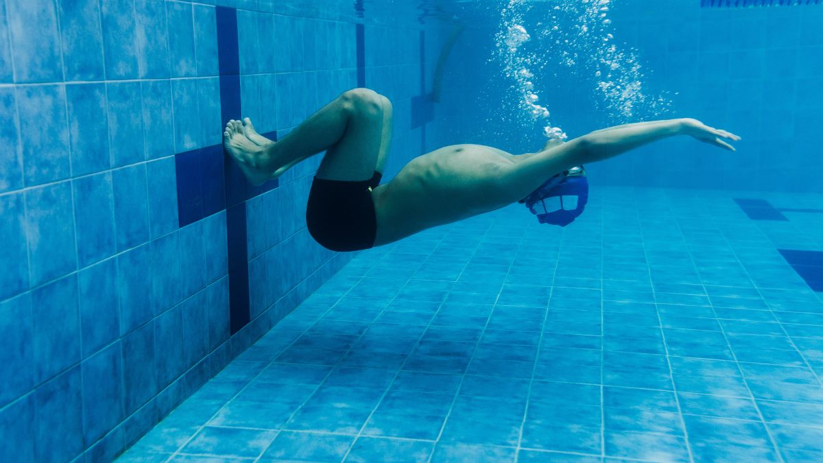 man doing flip turn swimming