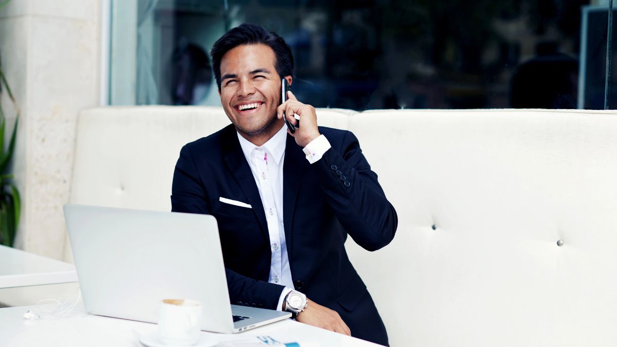 man on phone and computer