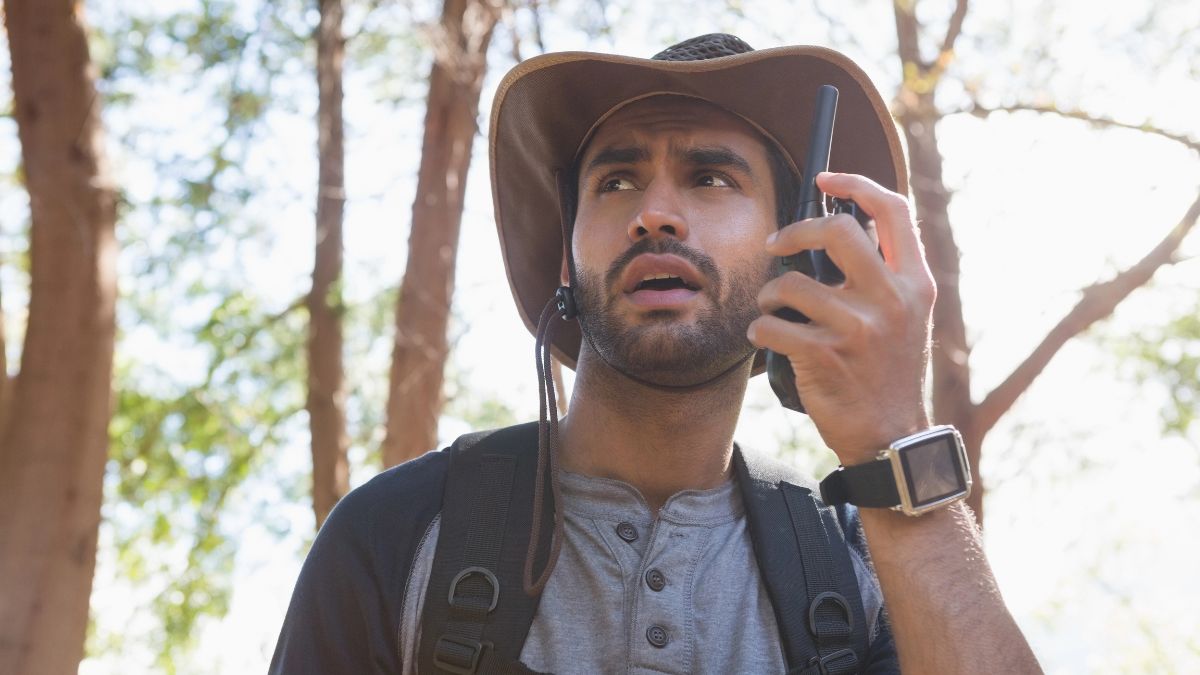 man on walkie talkie in the woods