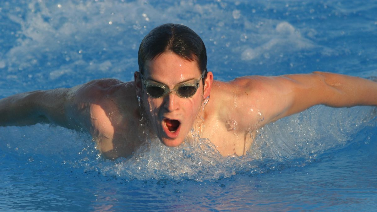 man swimming butterfly