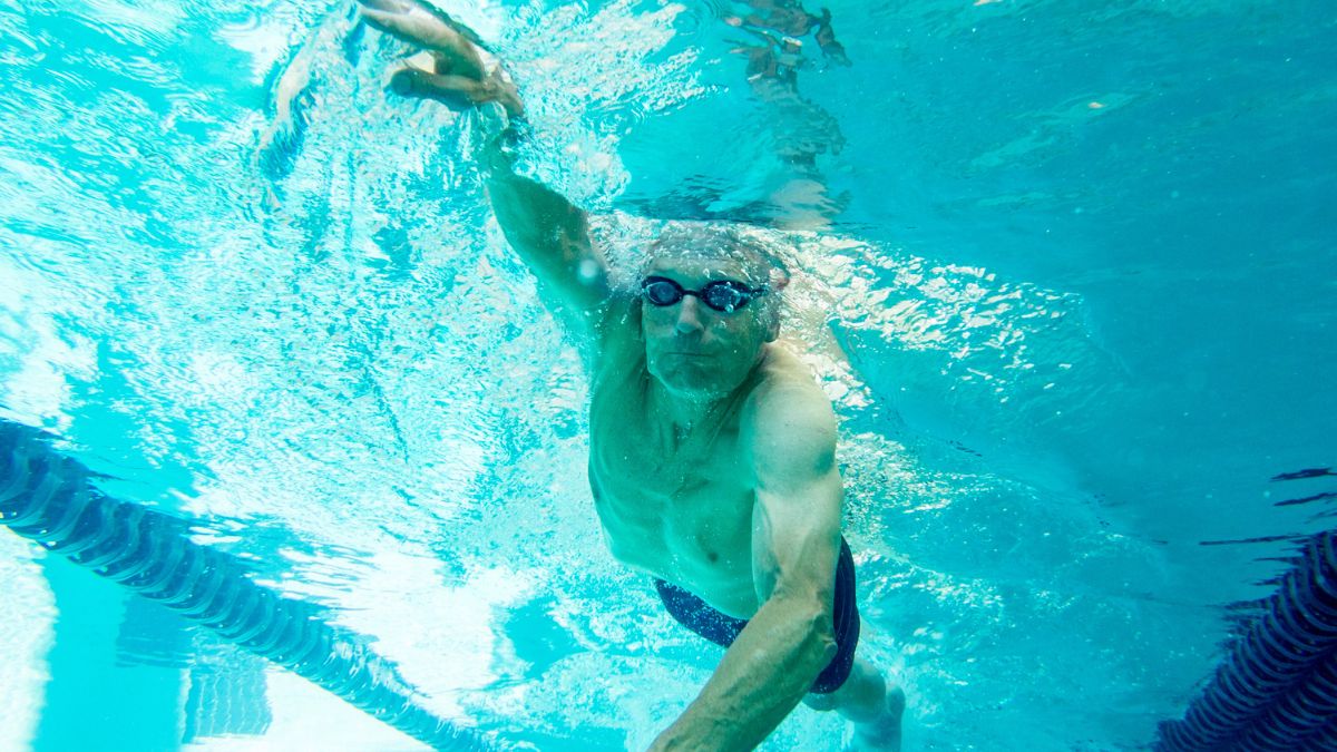 man swimming freestyle