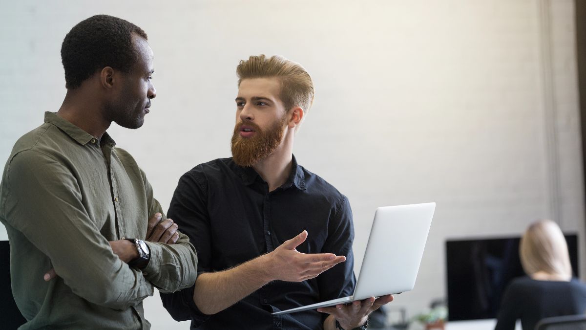 men talking with computer at work