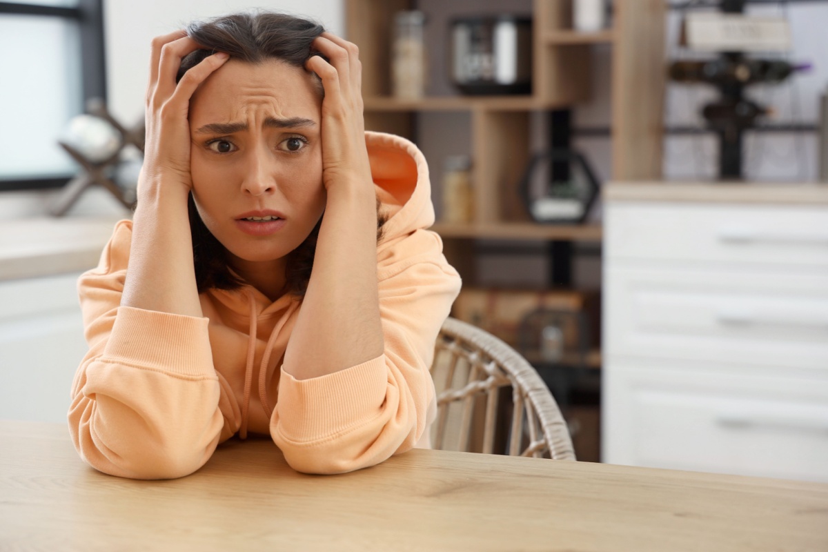 scared woman sitting at table