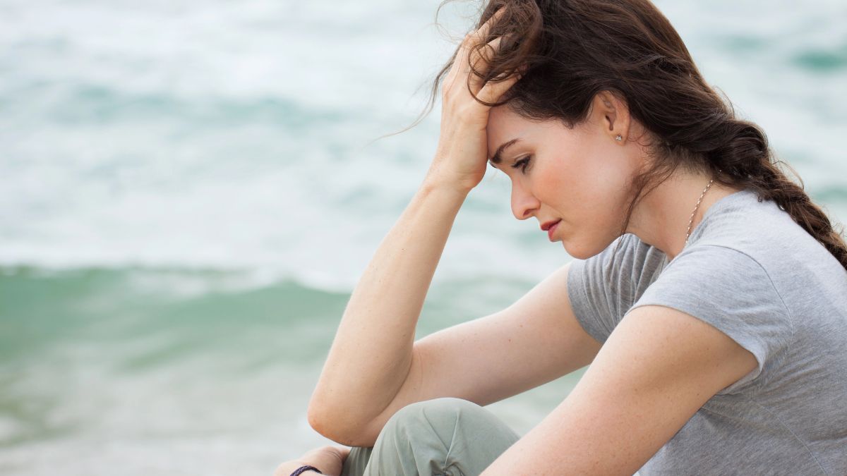 upset woman by the water