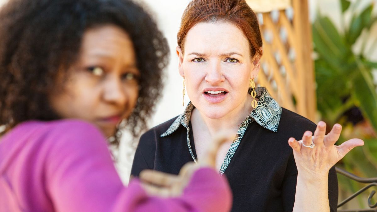 upset women talking at table