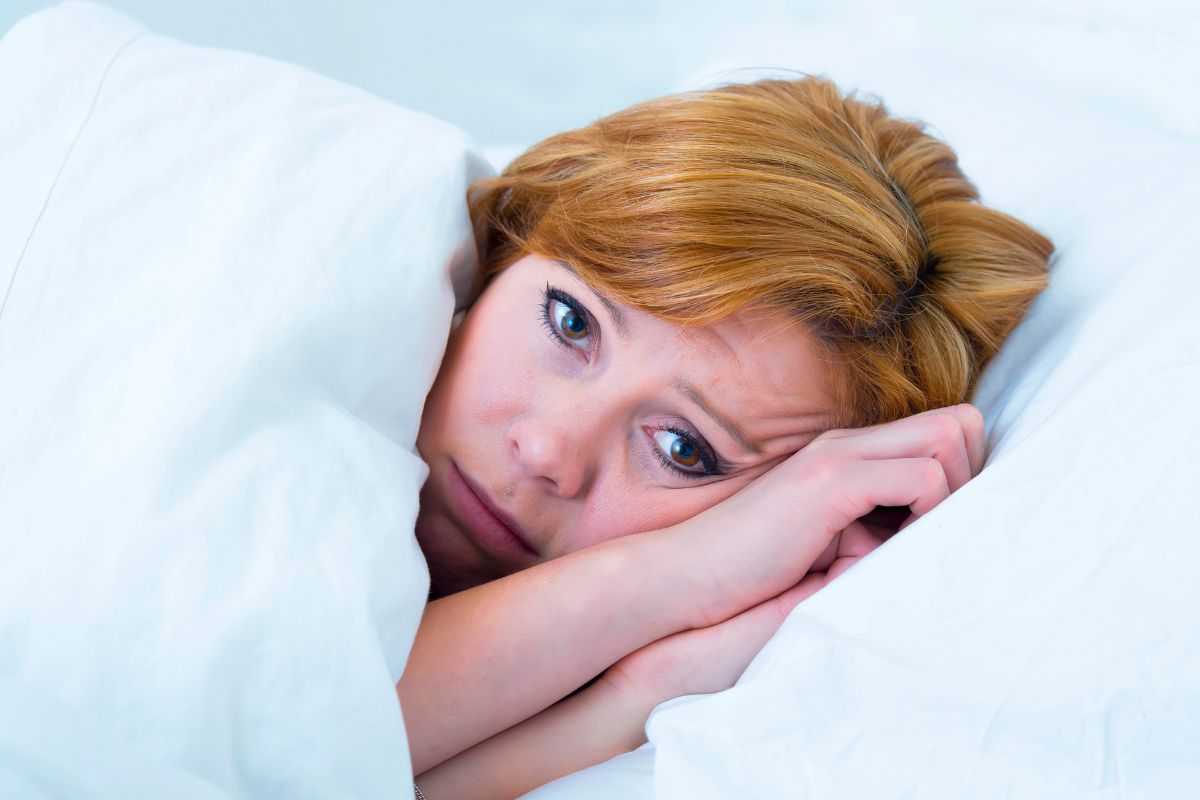 woman awake in bed.