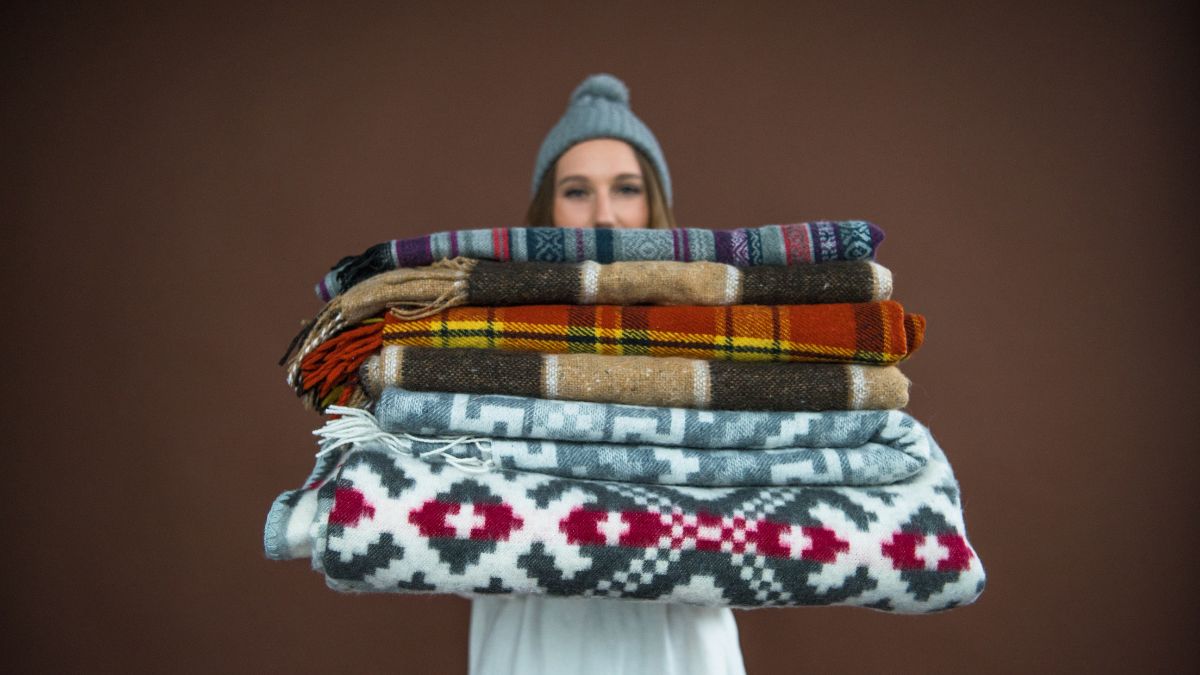 woman holding blankets