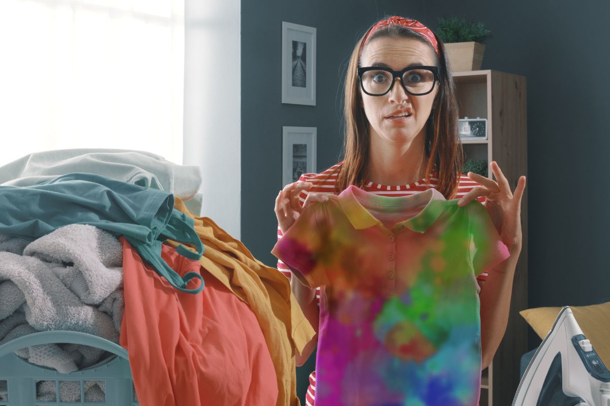 woman holding up a shrunken shirt.