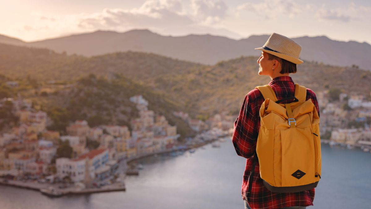 woman looking over water at city traveling
