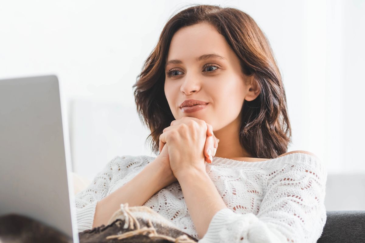 woman wrapped in a cozy sweater at home