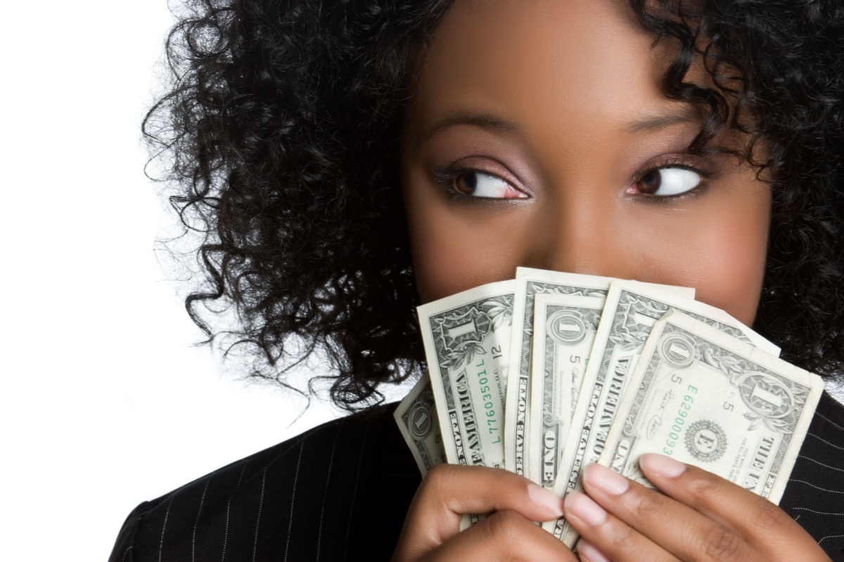 Black woman holding money one dollar