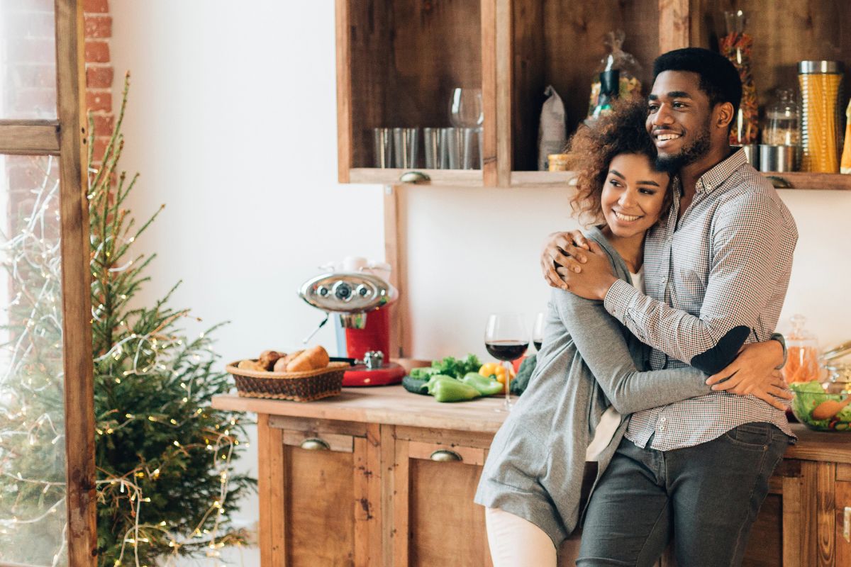 COUPLE in a cute apartment decorating for christmas