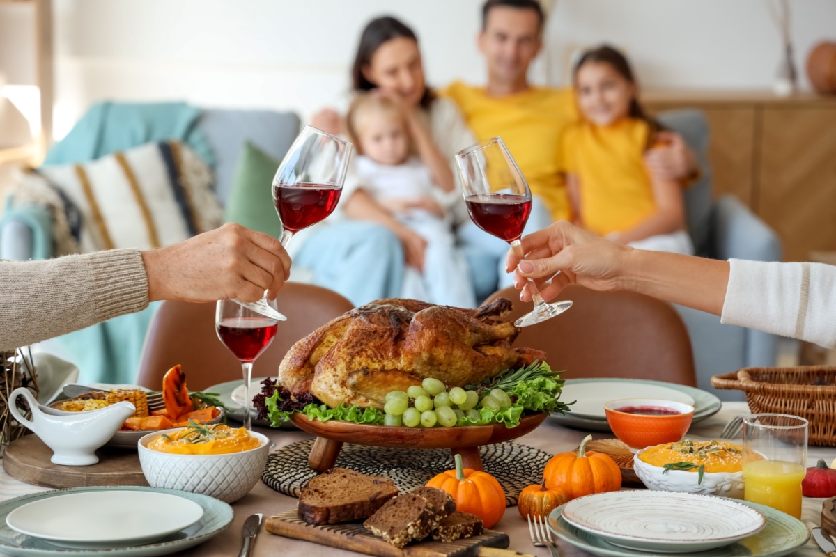 Mature couple having dinner at festive table on Thanksgiving Day