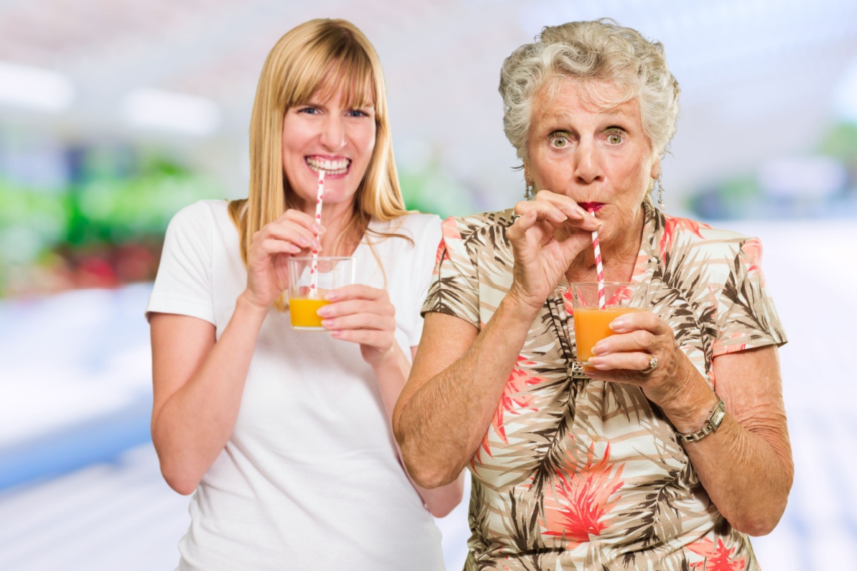 Two Happy Woman Drinking Juice