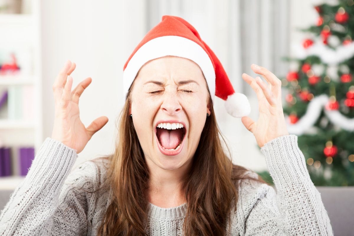 Woman wearing a santa hat screaming