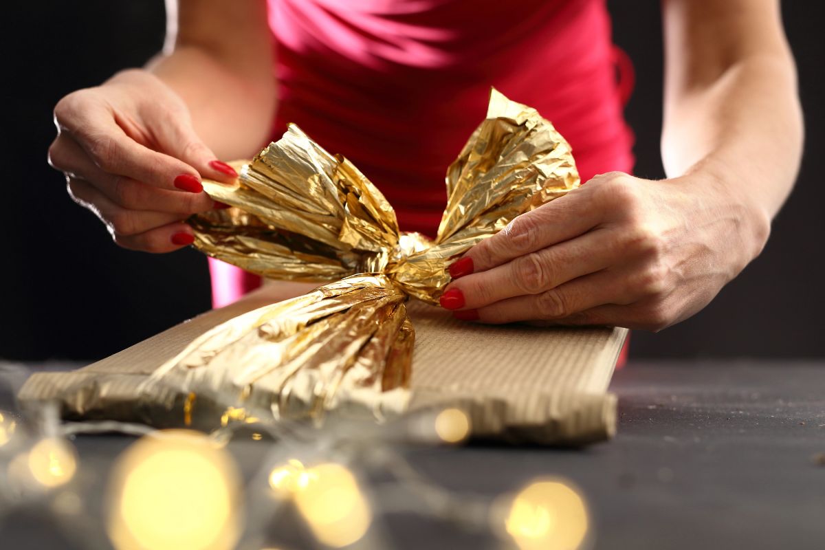Woman's hands wrapping a bow
