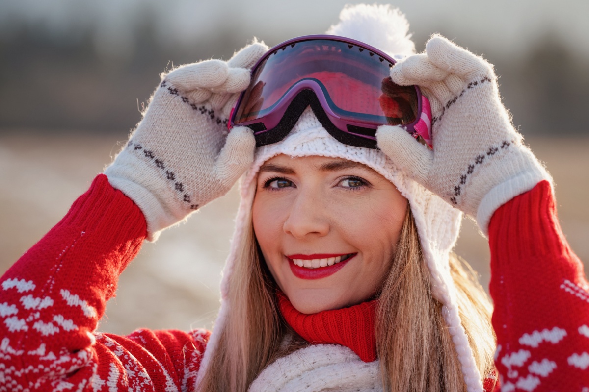 Young woman in red winter pullover skier