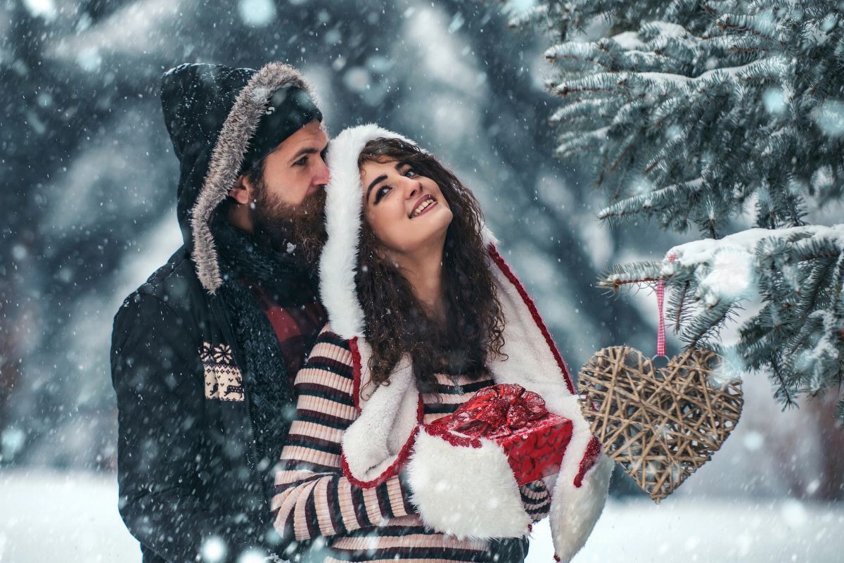 a couple in the snow together hugging