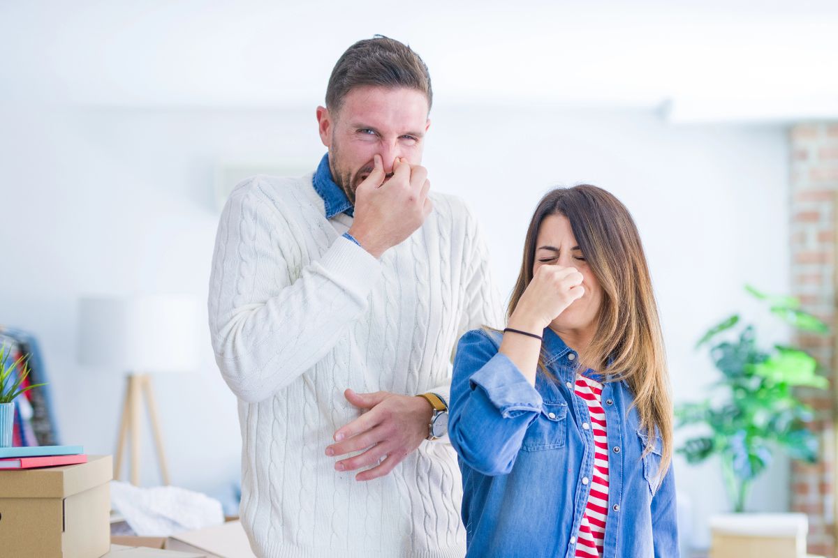 couple holding their nose because it smells