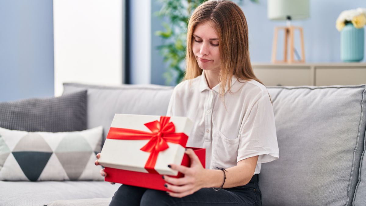 disappointed woman looking in a box