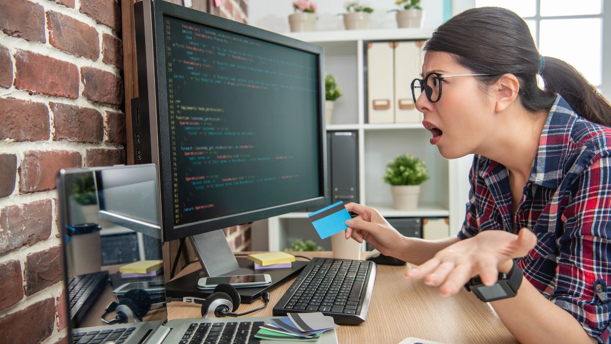 frustrated woman at computer with card