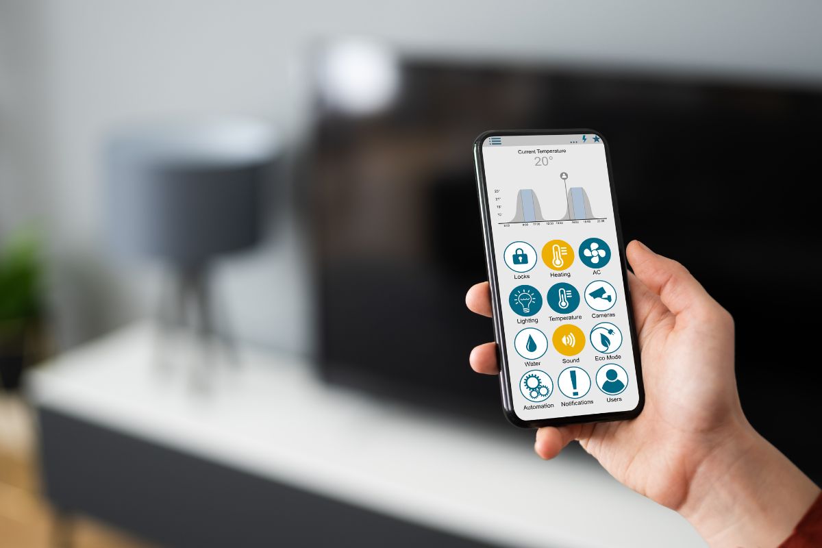 hand holding a phone with apps on it