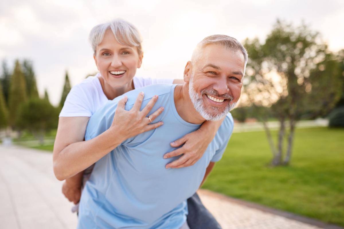 healthy middle aged couple retired running in park