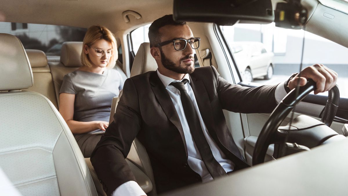 man driving woman in taxi