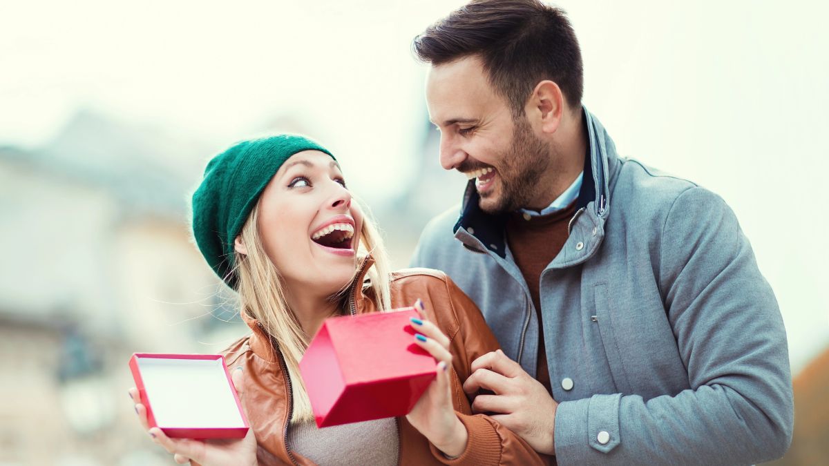 man giving gift to woman