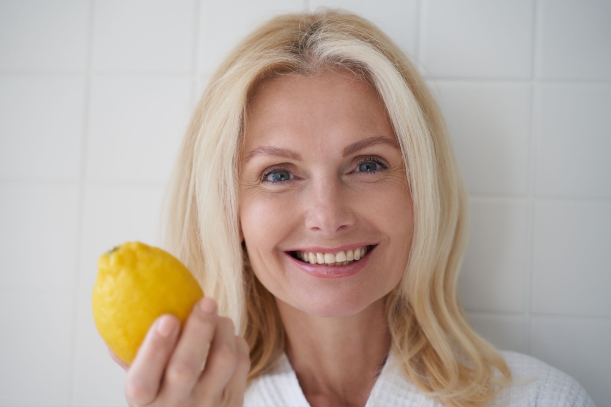 mature middle aged woman holding lemon