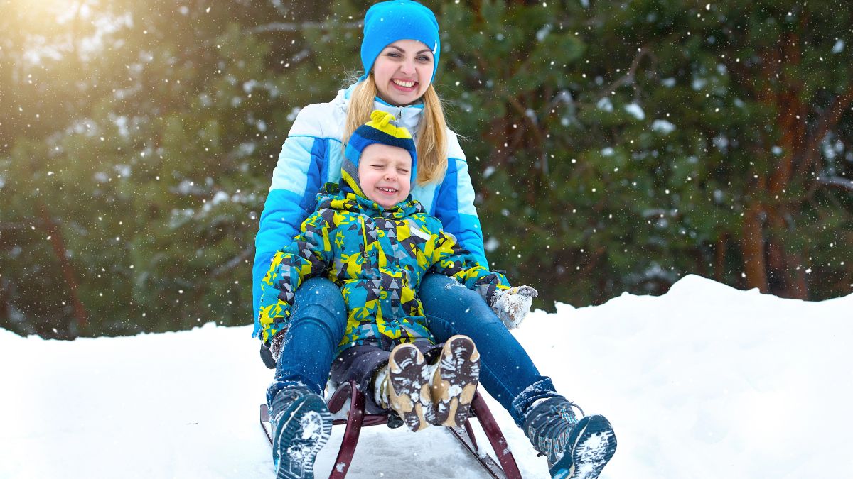 mom sledding with son