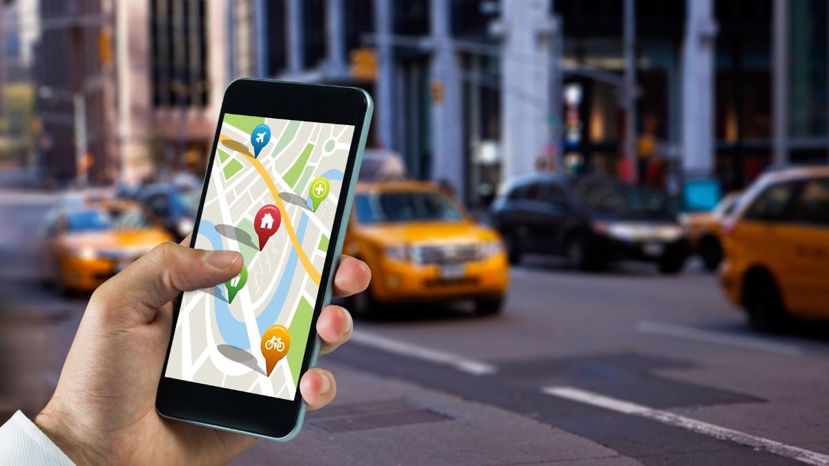 person with map on phone with taxies