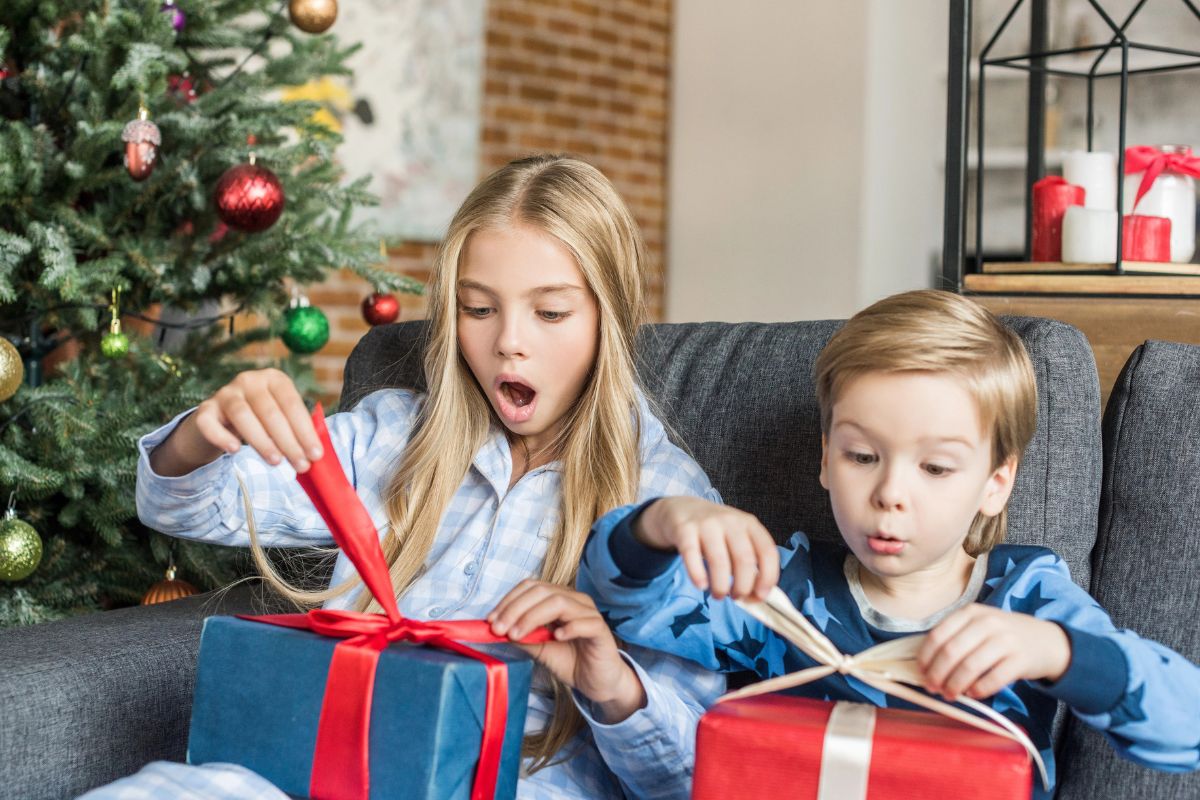 two kids about to open a christmas present