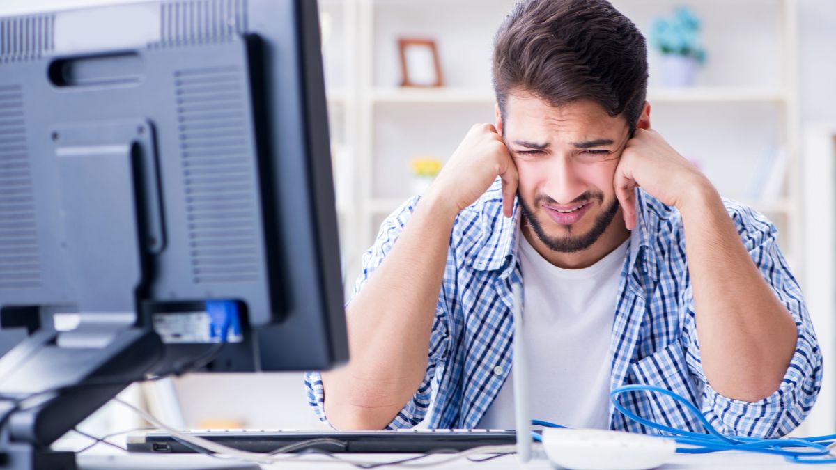 upset man crying at computer