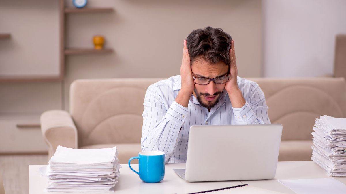 upset man looking at computer