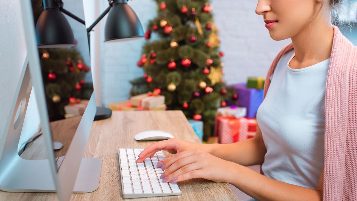 woman at desk with christmas tree