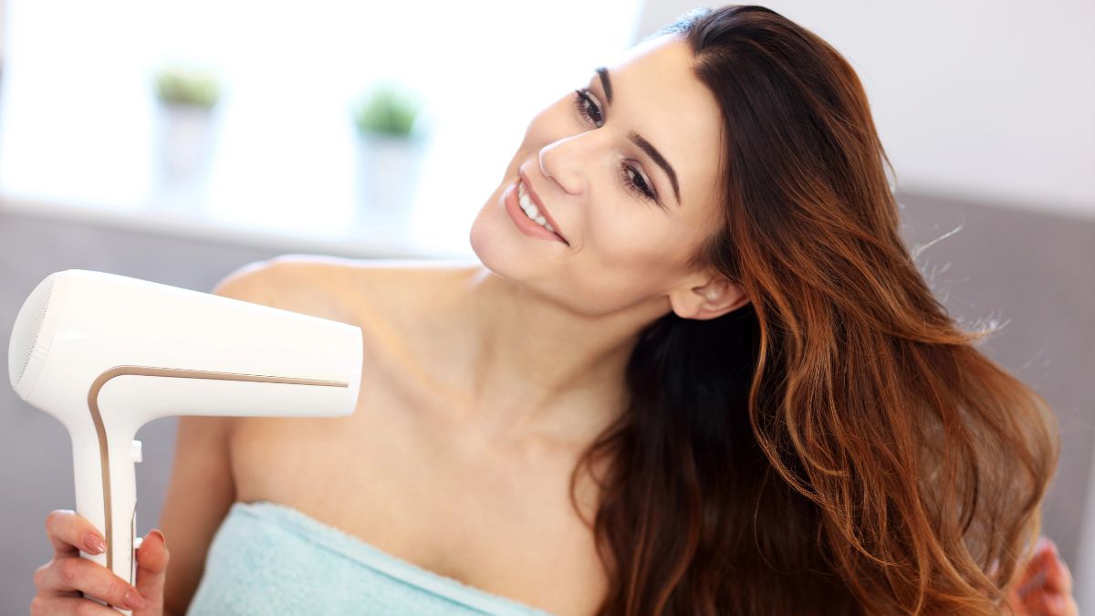 woman blow drying hair