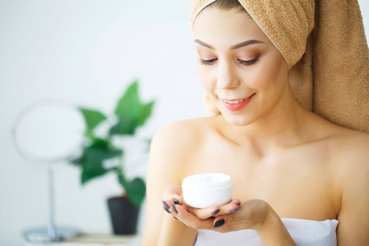 woman holding skin cream