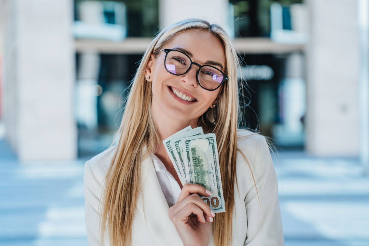 woman in glasses with American money