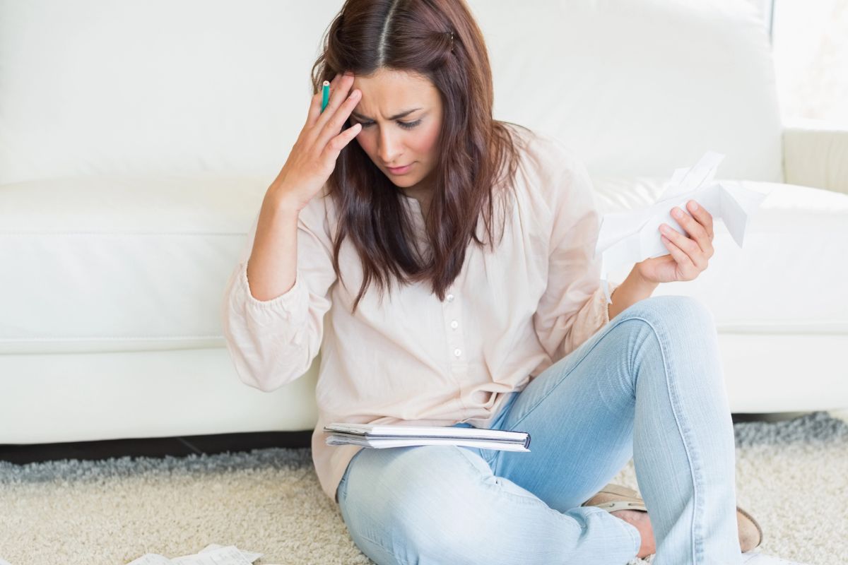 woman looking at her bills stressed