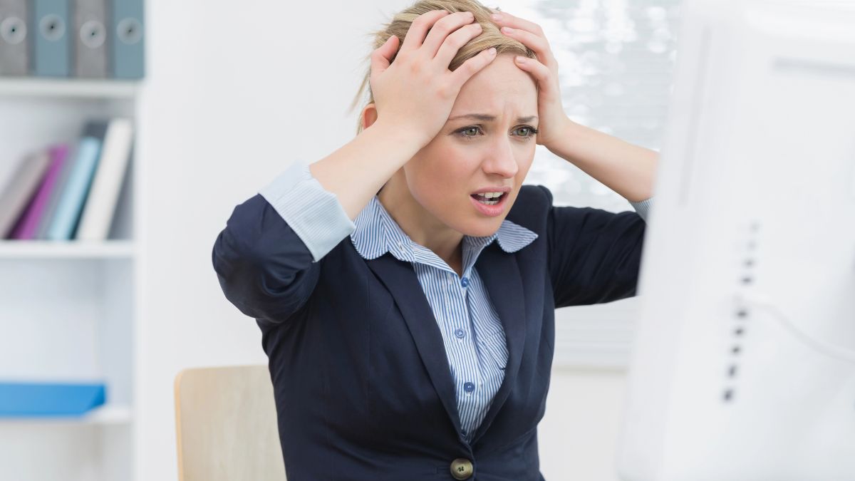 woman looking stressed at computer