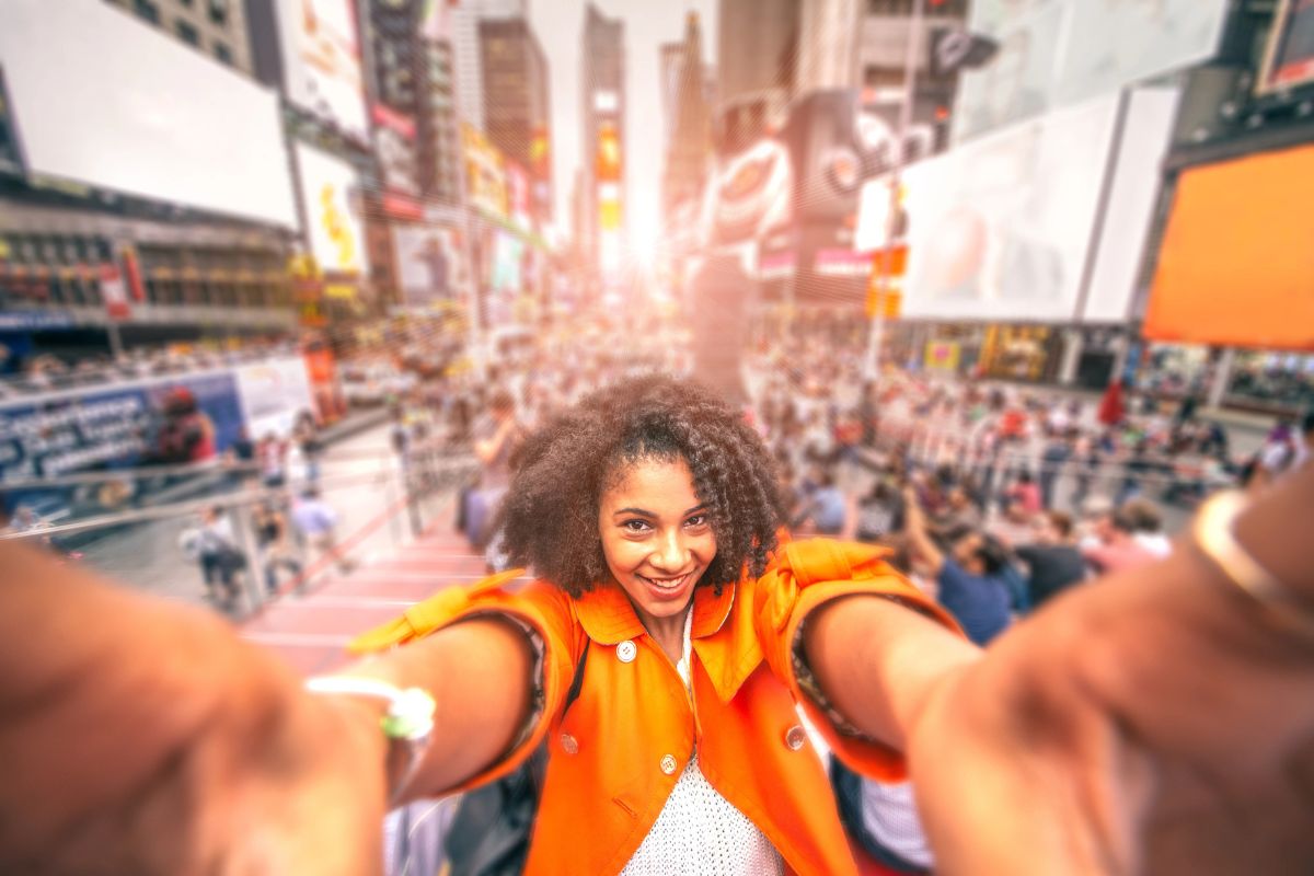 woman taking a selfie with new york in the background